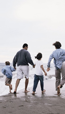 Family taking a walk on the beach